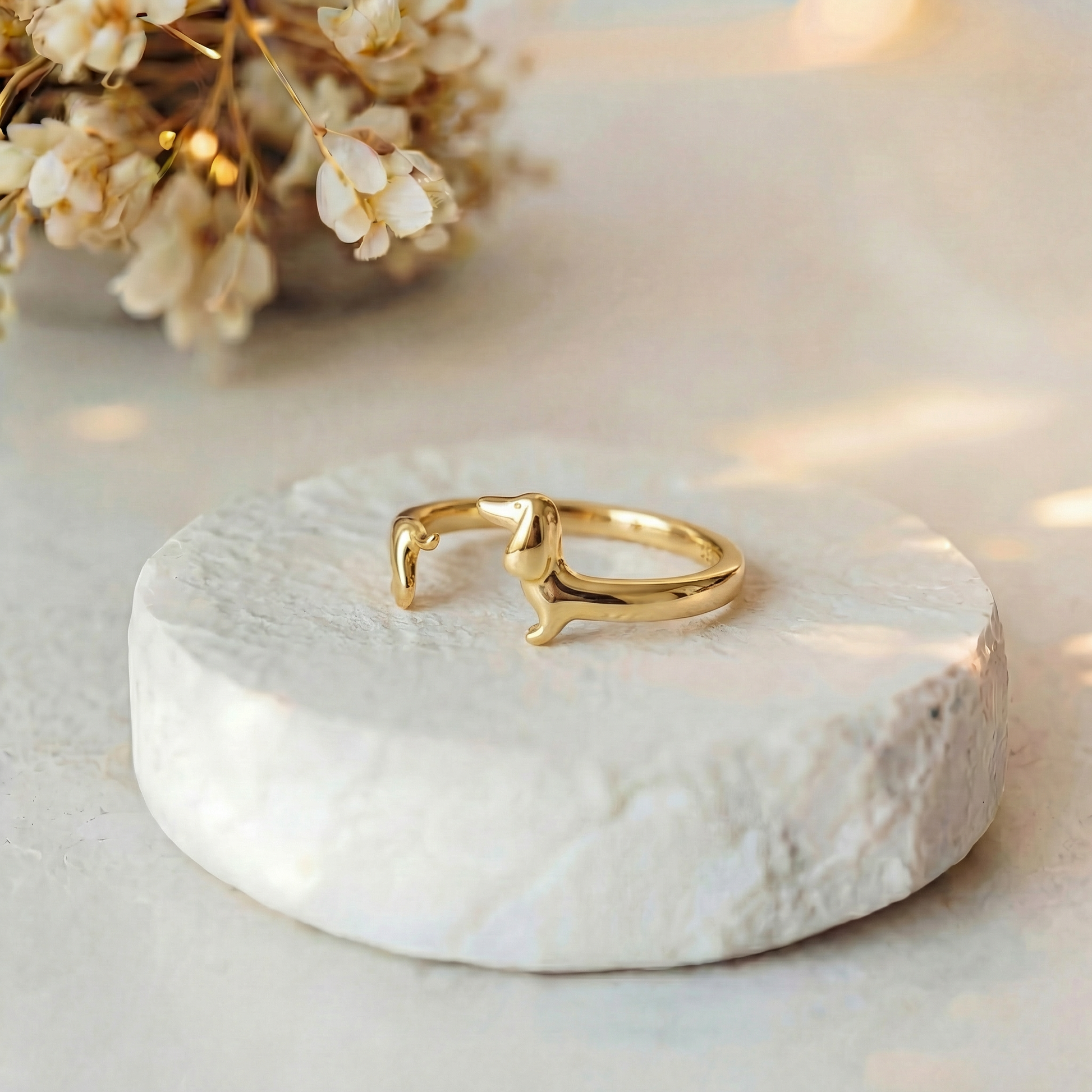 Teckel Wrap Ring gold on marble with flowers