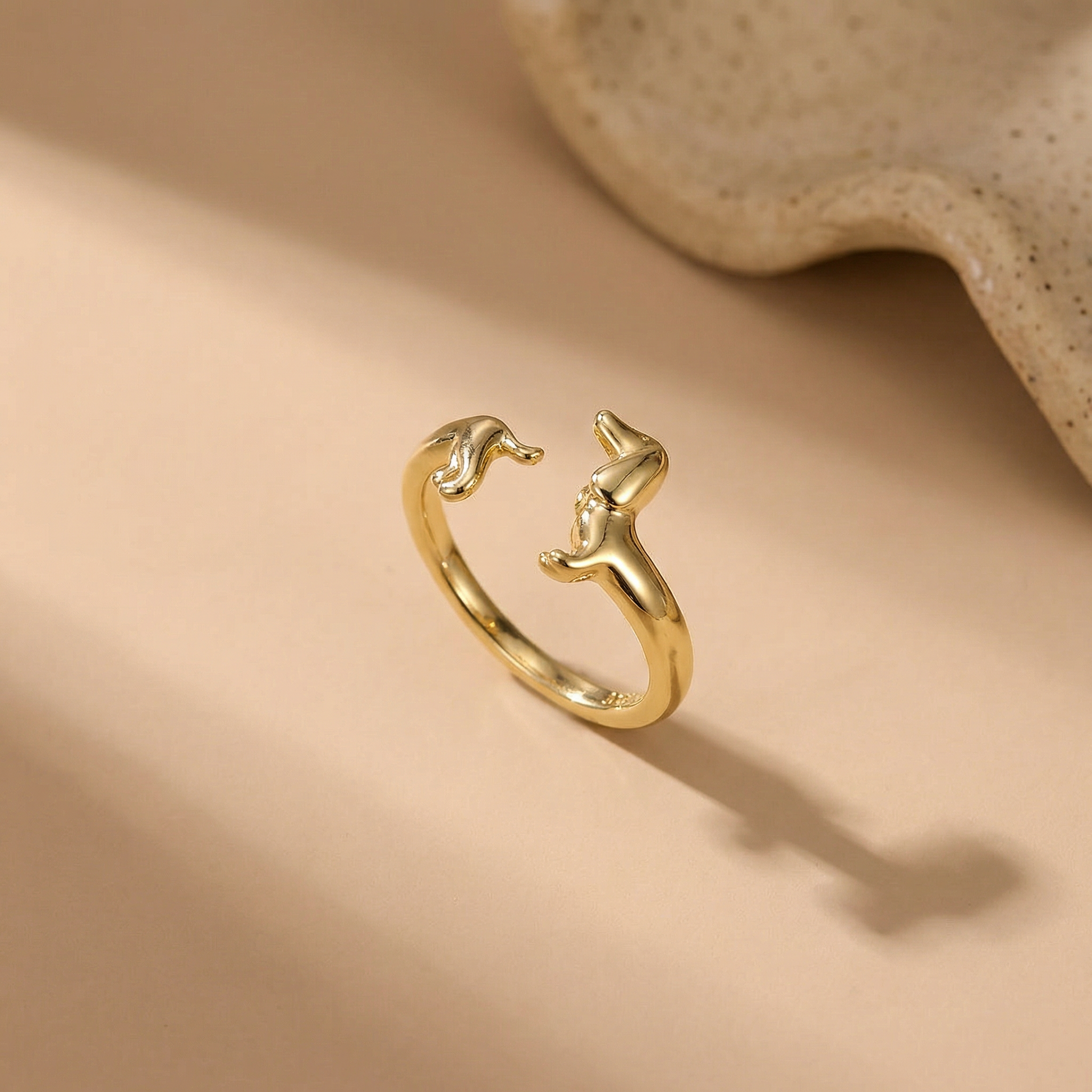 Teckel Wrap Ring gold styled on sand
